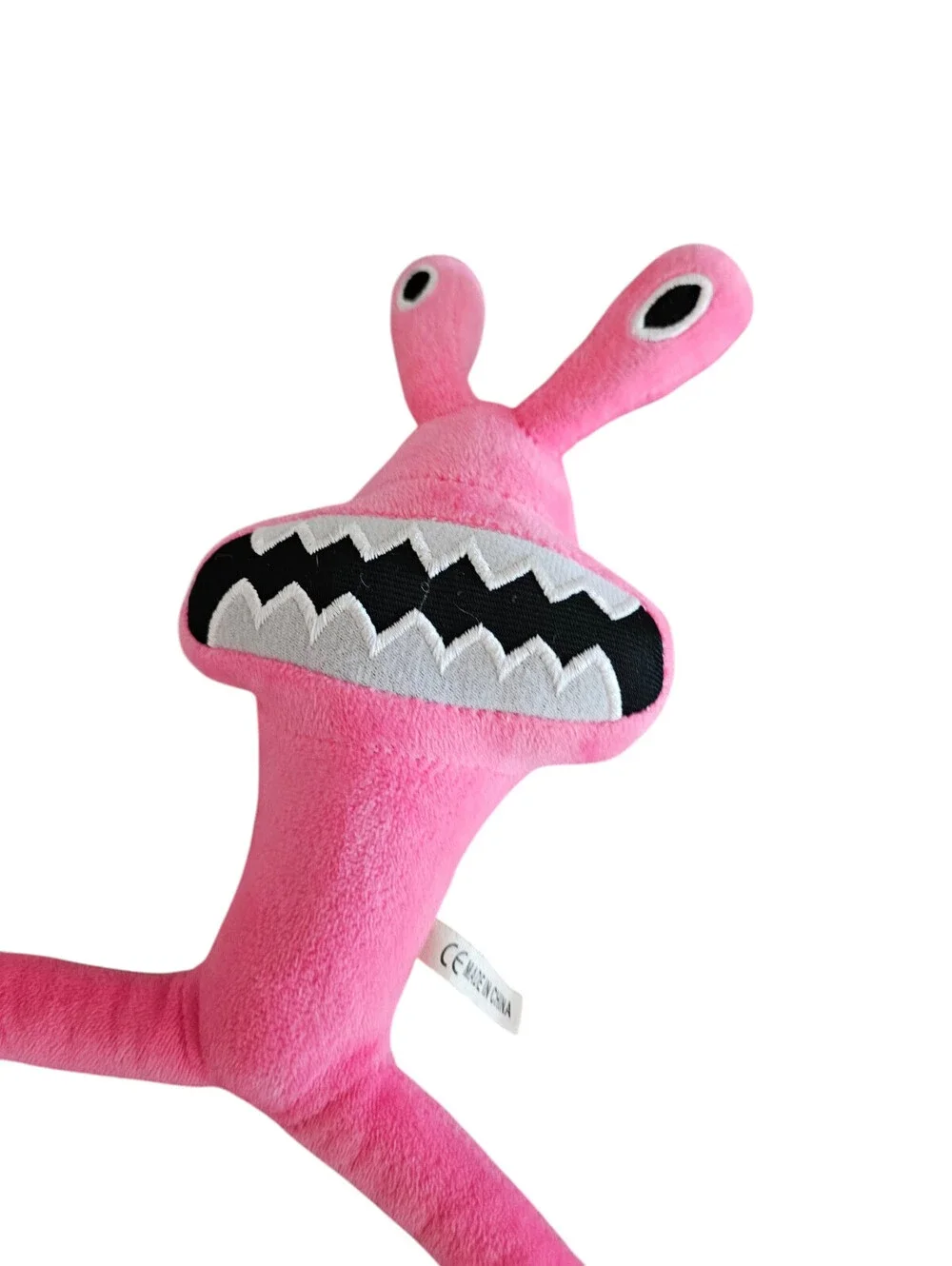Rainbow Friends plush toy is a bright pink character